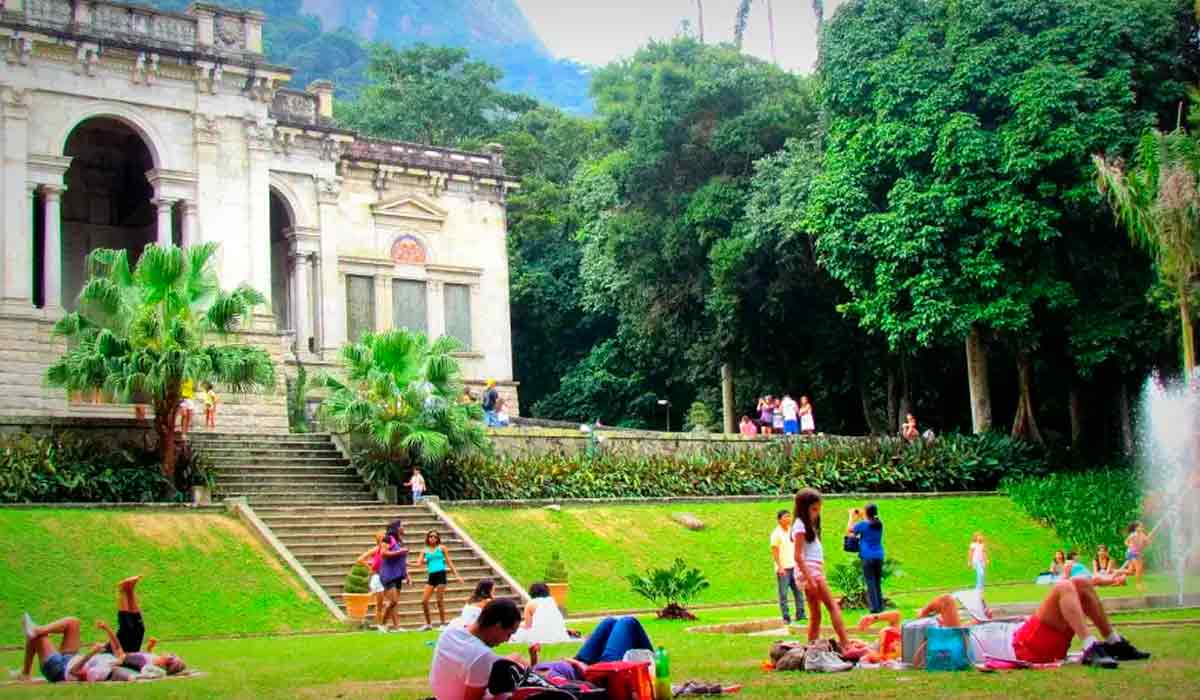 Parque Lage no bairro do Jardim Botânico, cidade do Rio de Janeiro, com a Floresta da Tijuca ao fundo e famílias com muitas crianças no gramado num fin de semana. Exemplo de uma metrópole com importantes áreas verdes para uso da população
