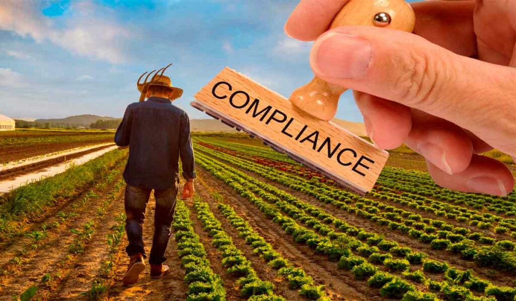 Carimbo com compliance e agricultor na lavoura ao fundo