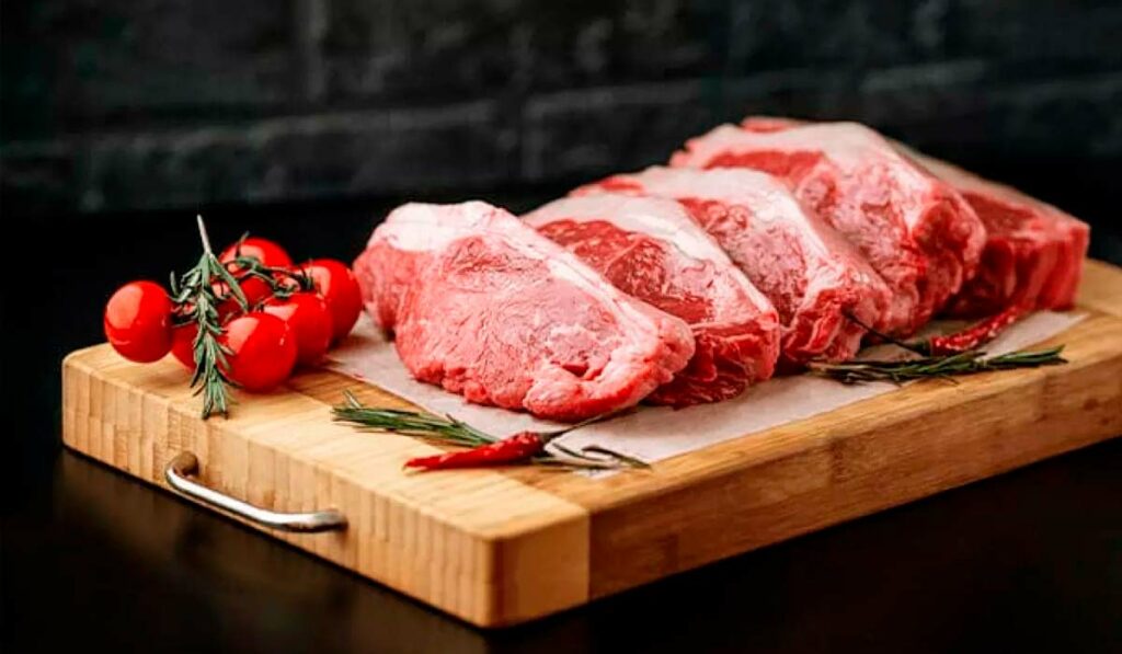 Peças de carne na tábua prontas para irem para a brasa