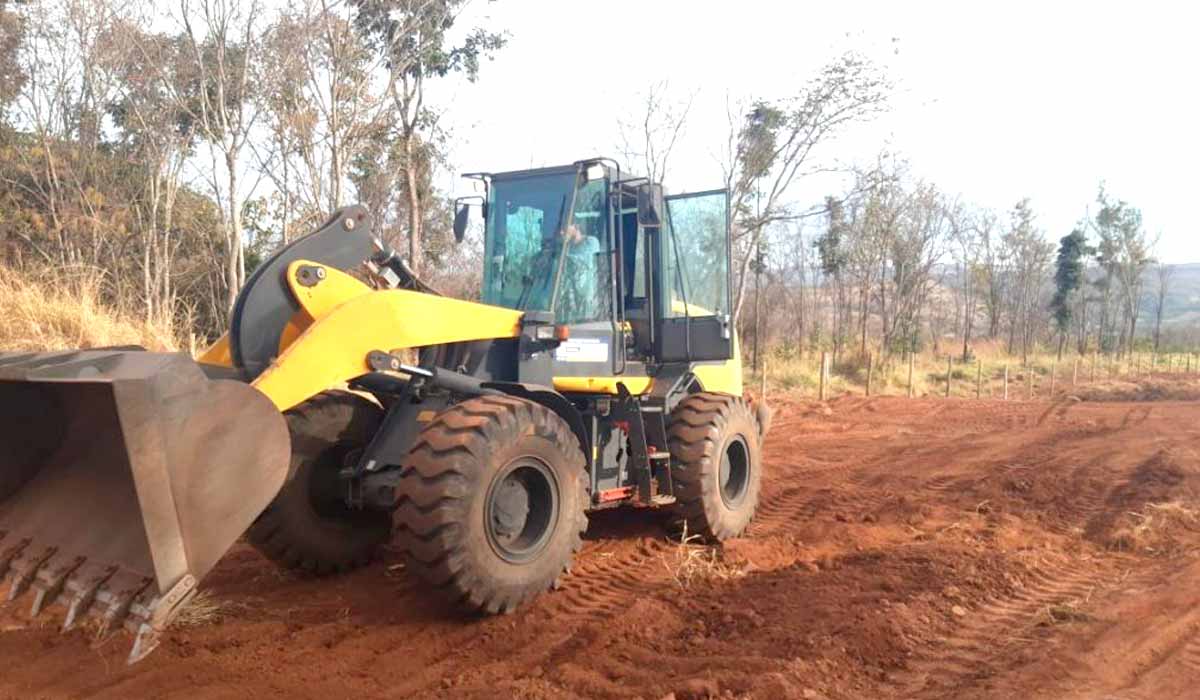 Pá carregadeira aplainando uma área de aceiro