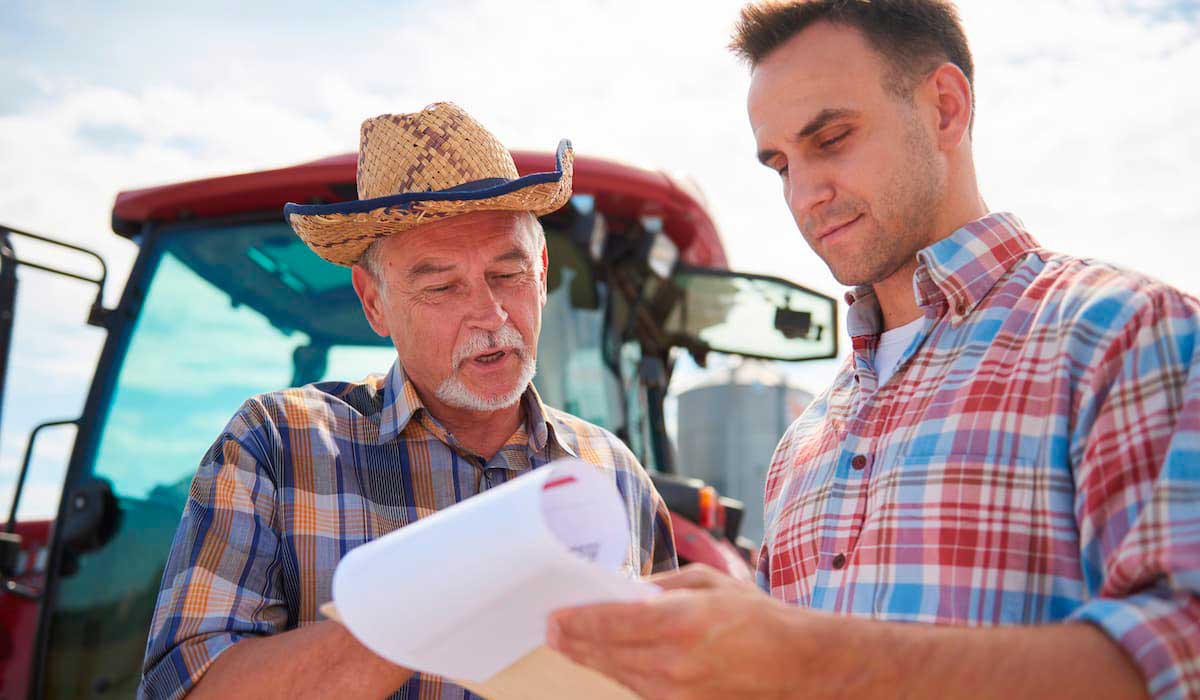 Produtor analisando proposta de seguro rural com agente securitário